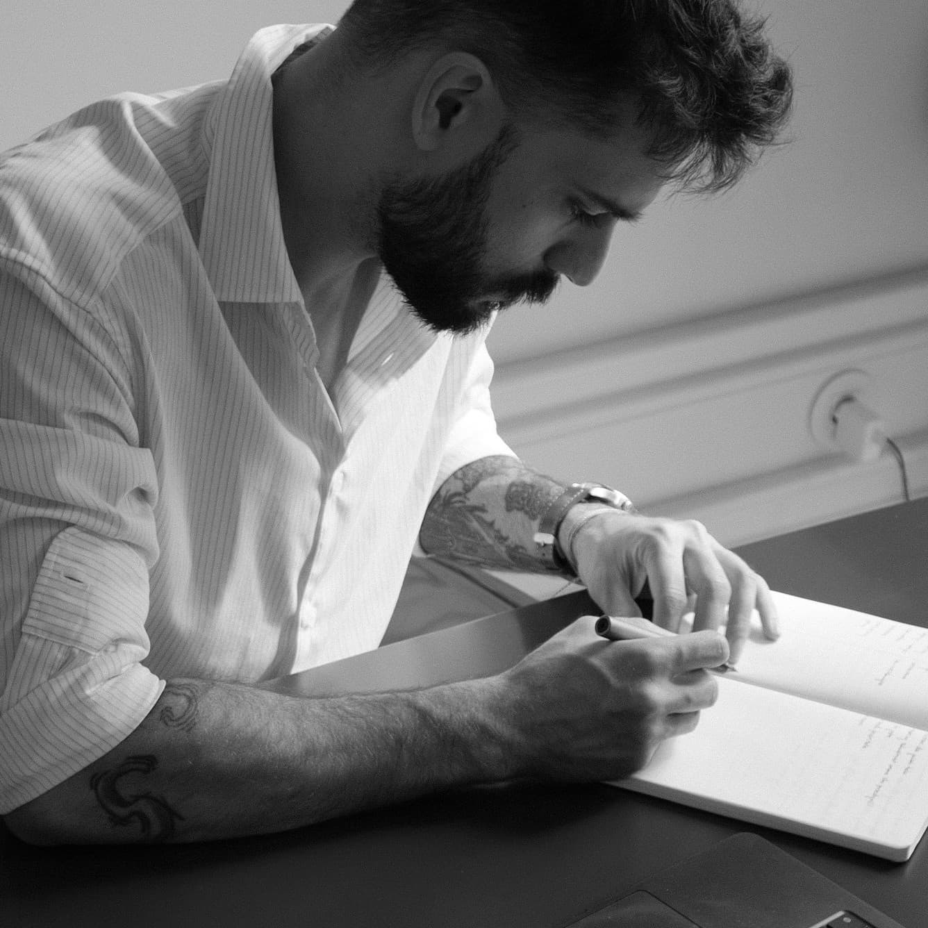 Ivan writing in a notebook at a desk